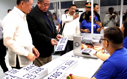 <p>Department of Transportation (DOTr) Secretary Arthur Tugade and Land Transportation Office (LTO) chief Assistant Secretary Edgar Galvante inspect the plate making facility at the LTO Central Office in Quezon City Tuesday. </p>